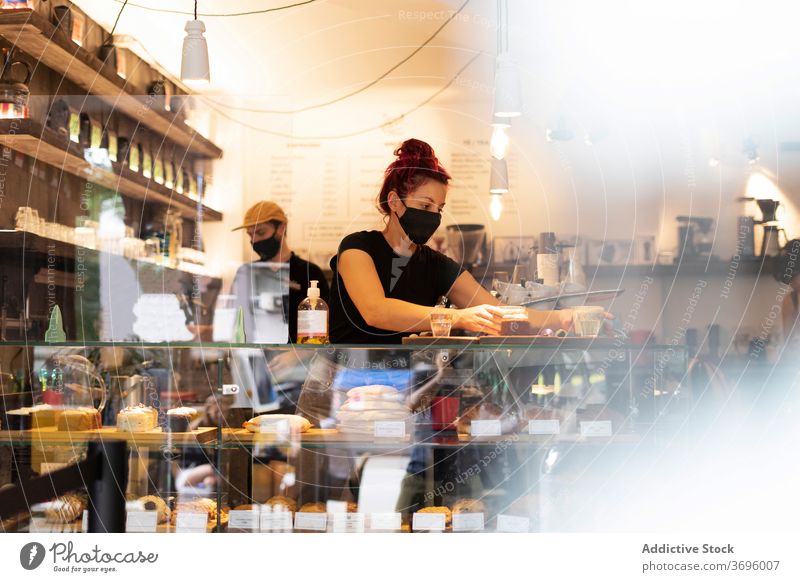 Waiter and waitress working in coffee shop barista prepare together coworker counter coronavirus mask new normal cafe delicious busy drink beverage cozy