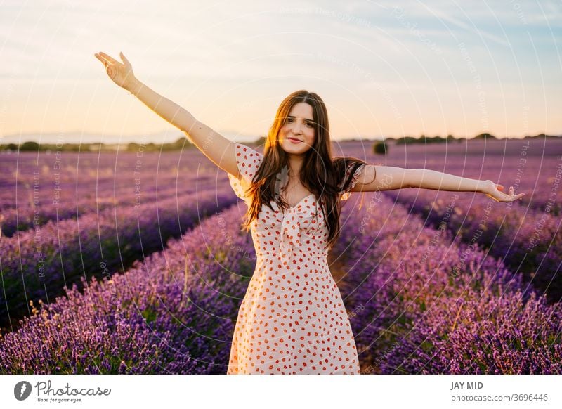 Happy woman in a dress and with open arms in lavender field. beautiful happiness lavander freedom smile young nature purple spring model summer hair people