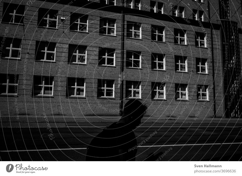 Shadow of a person in front of a house Exterior shot Light City people Modern Architecture Human being Wall (building) Town Lanes & trails Road traffic activity