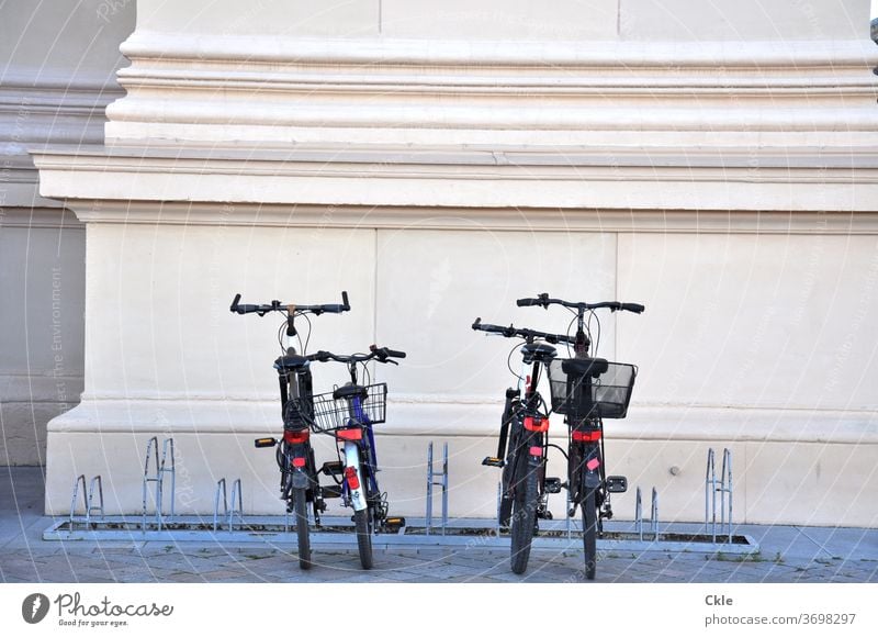 Classical modernity Bicycle Column Cacique classicistic Bicycle rack bicycles Parking area Parking lot Bike baskets Deserted Exterior shot Transport