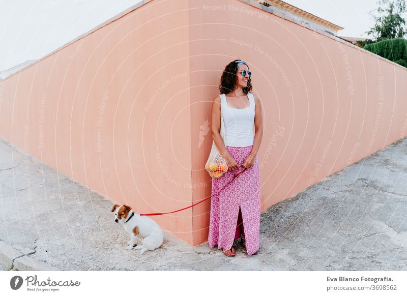 woman cute dog woman walking by the city, holding a cotton bag with fruit. Eco friendly, zero waste concept pet eco friendly owner jack russell city urban