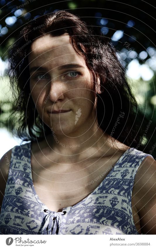 Close portrait of a freckled woman in a forest in summer Delicate Shadow Light Athletic Feminine empathy Emotions emotionally Looking into the camera