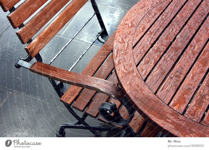 Left out in the rain Table Chair wood Furniture Seating Backrest Wooden chair Brown Wet raindrops Outdoor furniture Beer garden outside gastronomy Terrace