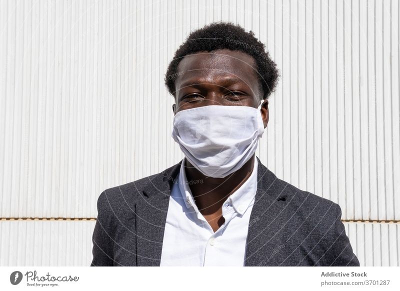 Cheerful black businessman in protective mask coronavirus pandemic covid cheerful entrepreneur formal portrait positive street young african american ethnic