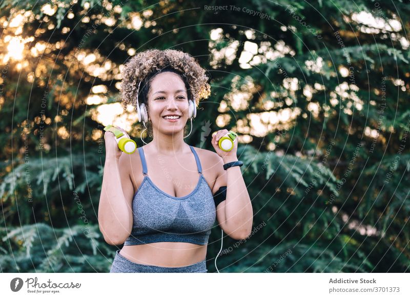 Doing sport. Young active fit woman with long legs listening to music and  doing sport Stock Photo - Alamy