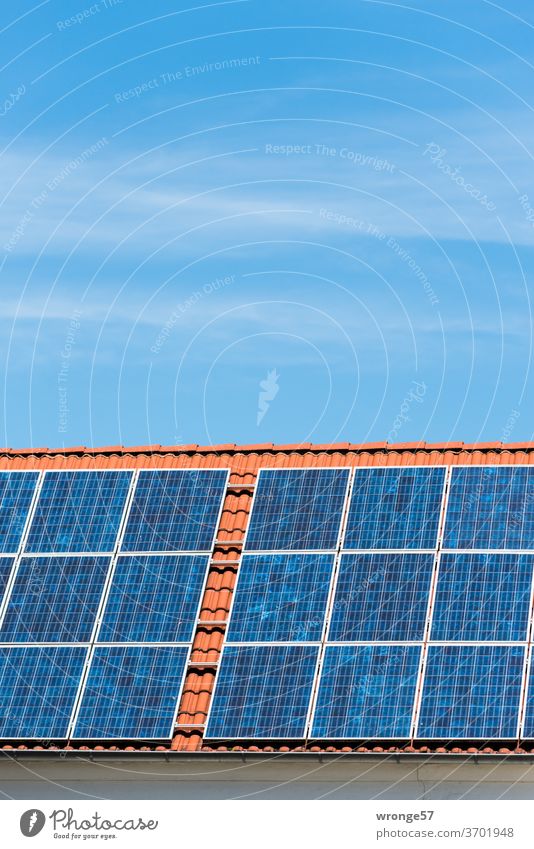 Close-up of a solar plant on a red tiled roof under a blue sky Solar system Solar Power Solar Energy Photovoltaic systems Solar cells electricity Colour photo
