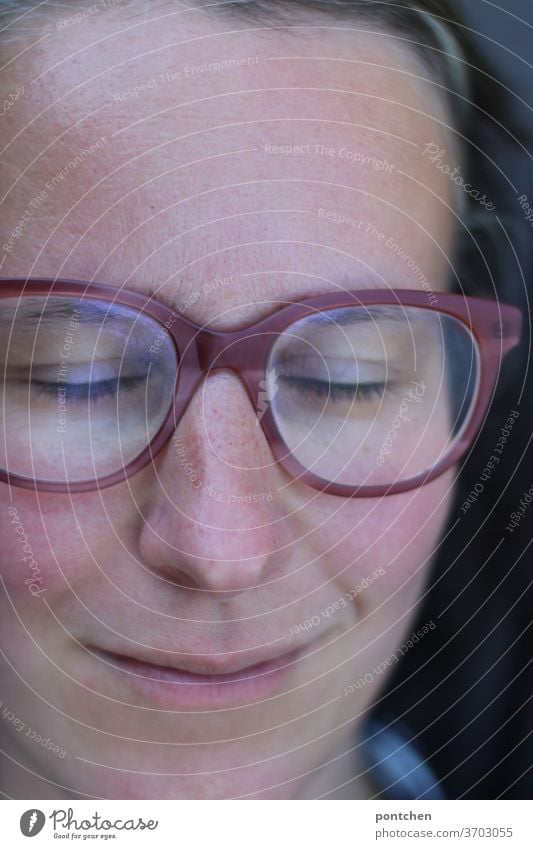 Face of a smiling woman with glasses and closed eyes. Relaxation and satisfaction Woman Eyeglasses smile relaxation Contentment Sleep doze Closed eyes Freckles