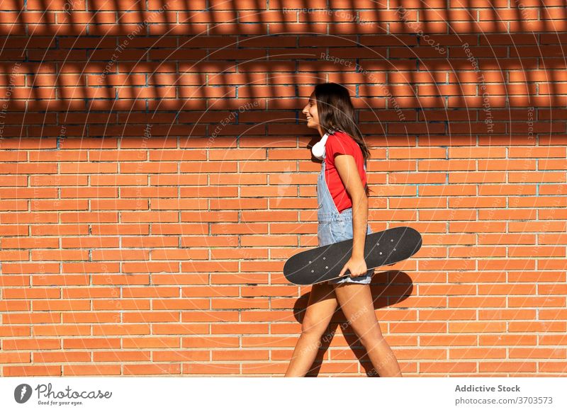 Cheerful woman with skateboard in city millennial having fun skater cheerful laugh funny female urban generation young joy smile trendy carefree cool enjoy