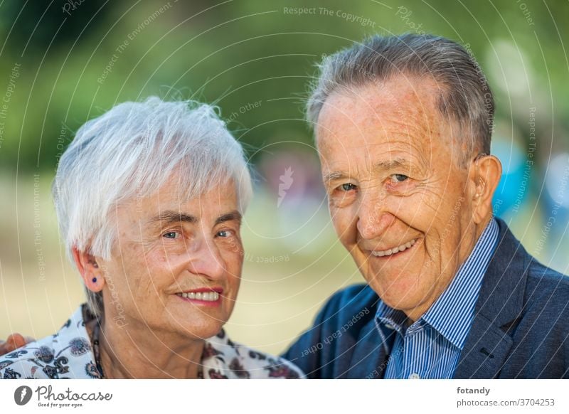 Nice couple of pensioners Married couple Adult Spring Life Portrait Pensioner Senior outside side by side older Happy together green Caucasian cheerful smile