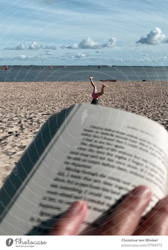 Opposites | rest and exercise on the beach... Beach Reading vacation turn wheels Beach life tranquillity Child Gymnastics North Sea beach Relaxation Book Sand