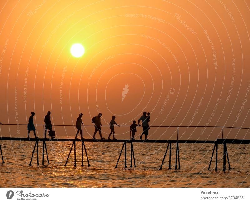 People on a jetty, in the evening side turkey Turkish Riviera Sunset Evening bridge Group group person persons Ocean Water ocean evening sky evening mood Beach