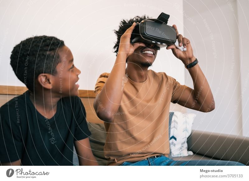 Two brothers playing video games at home. - a Royalty Free Stock Photo from  Photocase