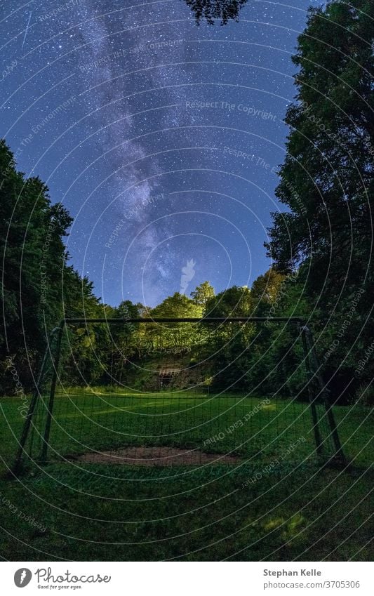 The Milky Way rises over a goal in the foreground. milkyway night sky star space nobody trees starry grass landscape galaxy constellation nature free universe