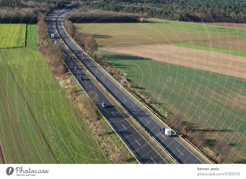 Landscape with two-lane federal road as aerial photograph Federal highway Street two lanes Transport cars Motor vehicle lorry Traffic infrastructure lorries