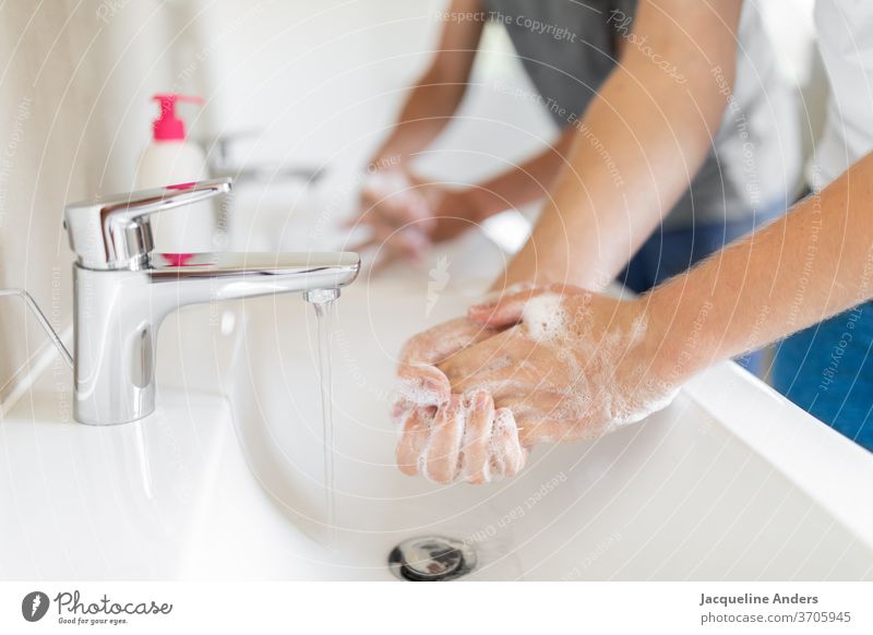 two men washing hands during the Corona pandemic Washing hands hygiene coronavirus covid-19 Healthy Soap Sink double washbasins Water Tap Virus Protection COVID