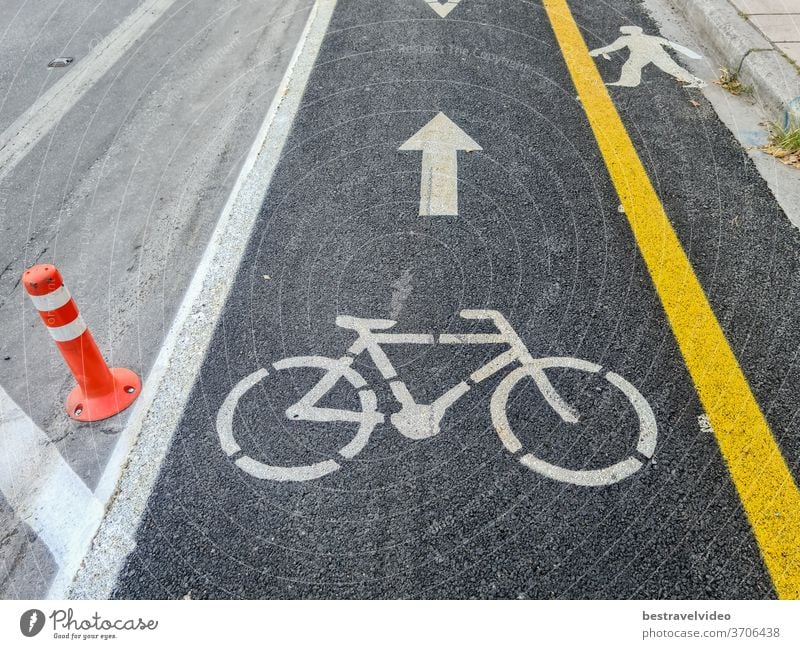 New urban transport bikeway with yellow separation line next to an asphalt road. Traffic only allowed to bicycles at marked bike path along the cycling infrastructure in Thessaloniki, Greece.
