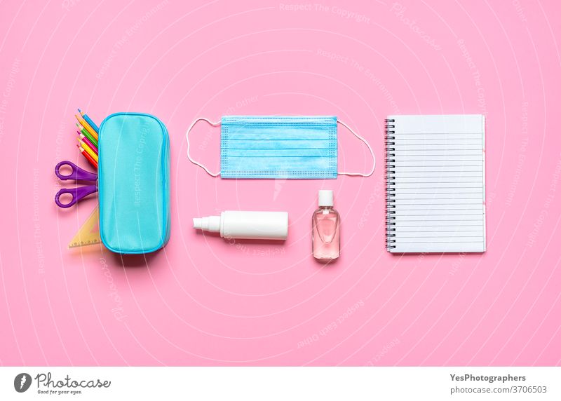 School supplies on a pink desk. Back to school pandemic requirements back back to school background blank blue concept corona covid covid19 creative layout