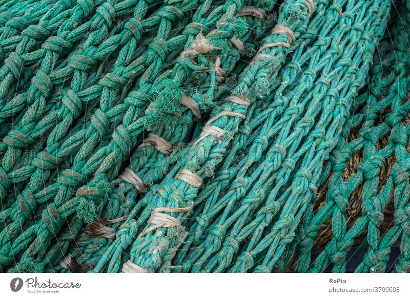 Used fishing nets on a pier. - a Royalty Free Stock Photo from