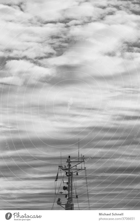 Mast of a fishing boat in front of a cloudy sky at the North Sea ship Exterior shot Black & white photo Clouds Clouds in the sky Black and white Fishing boat