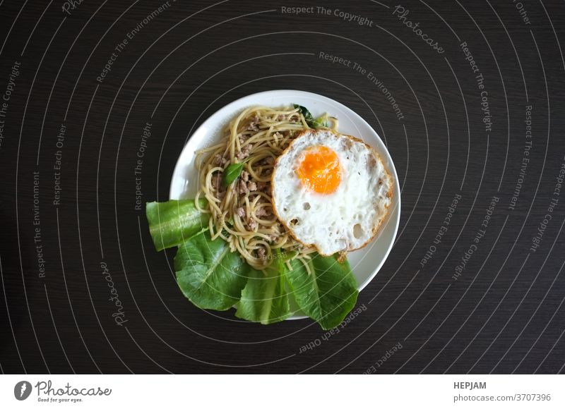 Spaghetti stir fried with Thai Basil spicy sauce with Fried egg  , fusion Thai style asia asian background basil closeup cooking cuisine delicious dinner dish