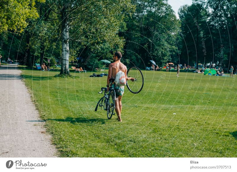 A man carries his bicycle because it has a flat tire Bicycle slabs Carrying Breakdown Broken on foot pedestrian Summer Trip Human being unlucky Meadow sunshine