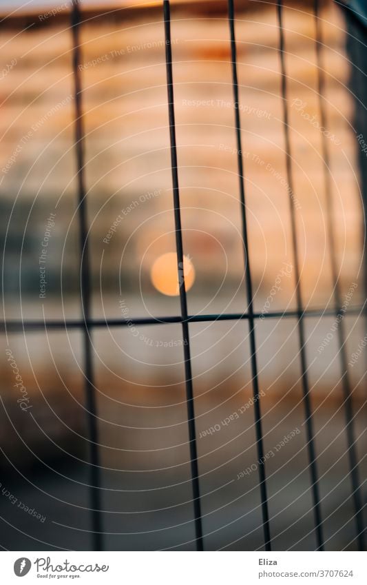 Light and warmth behind the fence Hoarding Construction site Fence Abstract cordon Safety Border Grating Apartment Building Warmth Metal Structures and shapes
