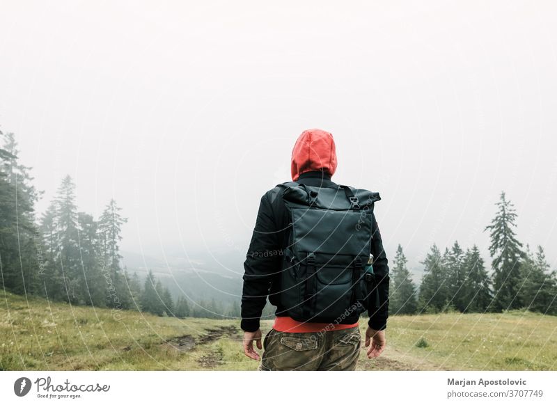 Nature explorer enjoying the view of  a foggy mountain range adventure alone backpack backpacker environment exploring forest freedom green hike hiker hiking