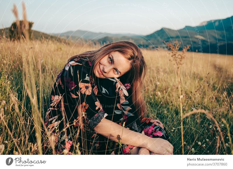 Happy Woman Enjoying Life In Field At Sunset In Mountains Stock Photo,  Picture and Royalty Free Image. Image 119496928.