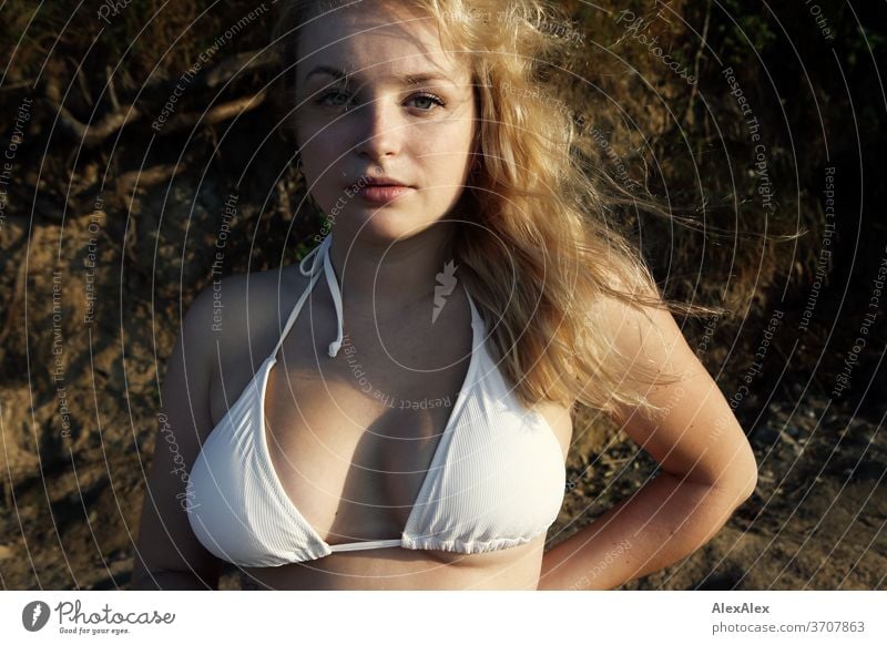 Portrait of a young, blonde woman in front of the cliffs at the Baltic Sea  - a Royalty Free Stock Photo from Photocase