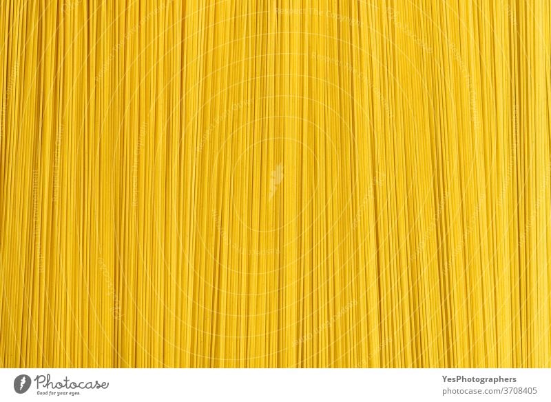 Raw spaghetti abstract background. Uncooked pasta top view. Pile of spaghetti above view carbohydrate carbs close-up comfort food cooking cuisine culinary