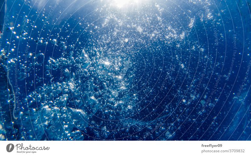 View from underwater with bubbles and the sun blue swimming pool drowning texture wave rippled infinite background salt water sunlight tropical aquatic ocean