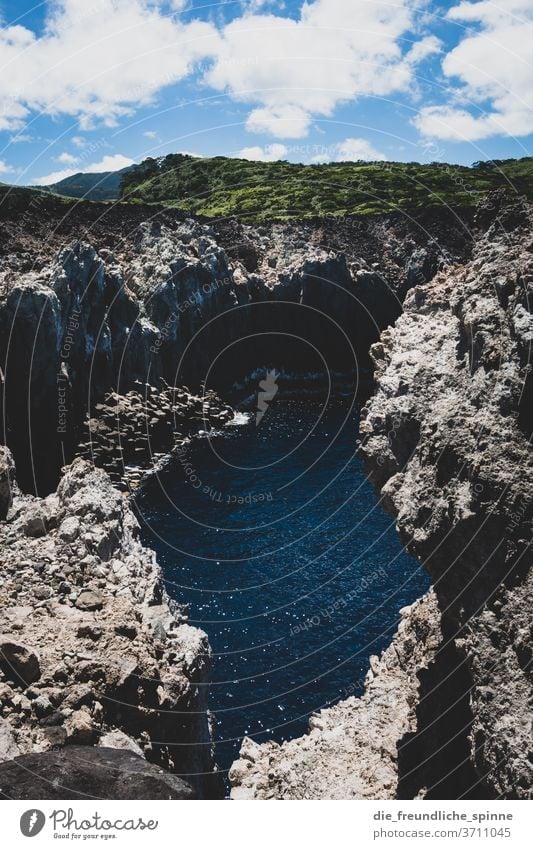 Azores Coast I Ocean Atlantic Ocean Stone Volcano green Sky Clouds Deserted Nature Water Blue Rock Exterior shot Colour photo steep coast Landscape Waves stones