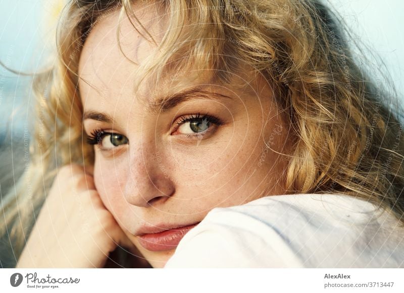 Young female model with braided blonde hair, big green eyes and decorative  black lace on her face, smiling, on white lace background Stock Photo -  Alamy