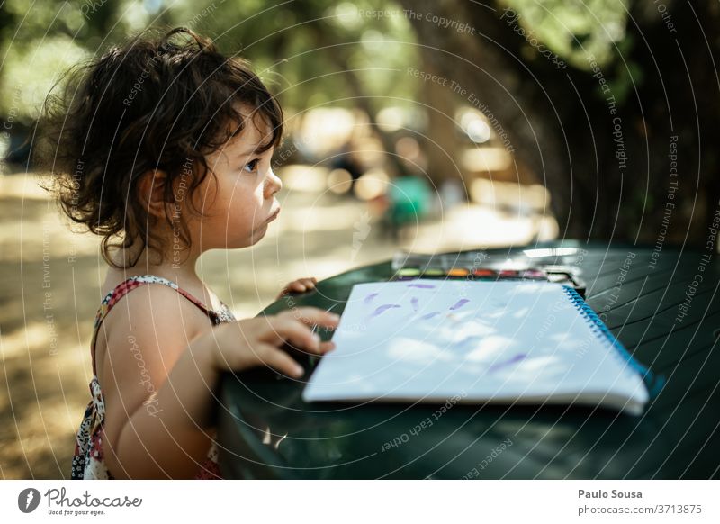 Child reading outdoors childhood Reading Leisure and hobbies Caucasian Happiness Portrait photograph Exterior shot Colour photo Lifestyle caucasian Human being