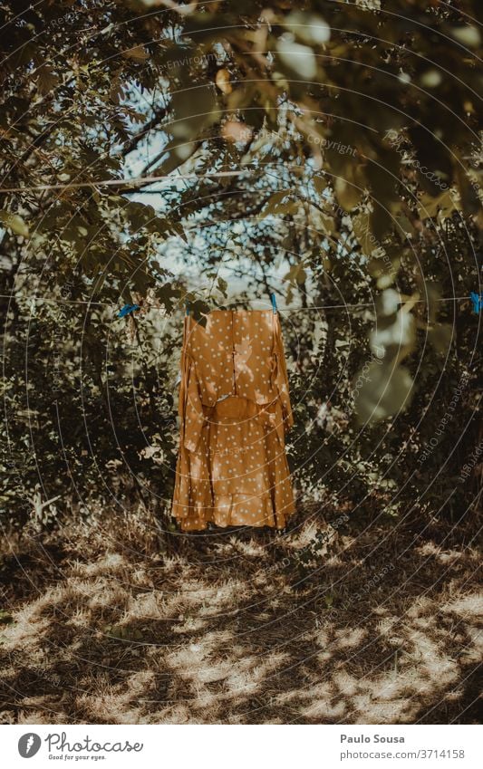 Yellow dress on the clothesline Clothesline Clothes peg Dress Summer Summer's day Hanging drying Colour photo Blue wash Clean Clothing White Exterior shot Dry