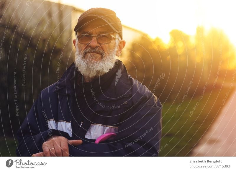 Portrait of a 75 years old man with glasses and beard, outside, at sunset Man older man Eyeglasses portrait Facial hair Sunset Senior citizen To go for a walk