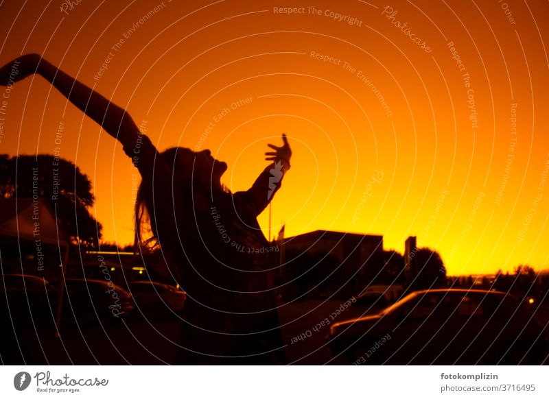 Silhouette of a woman stretching her arms into the red-yellow sky Happy Optimism Joy Happiness Movement Contentment Enthusiasm Emotions Joie de vivre (Vitality)