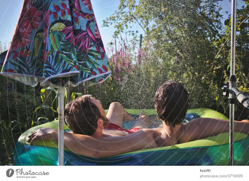 Two men in a pool water loving Summer vacation Vacation mood Garden green Water Swimming & Bathing Male preserve male love Friendship Blue Exterior shot