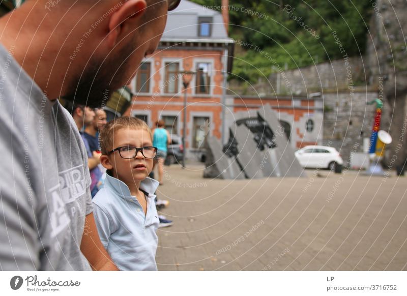 Boy wearing glasses having a conversation with his father Boy (child) Parents Parenting Child Infancy Adults Family & Relations Son Portrait photograph Together