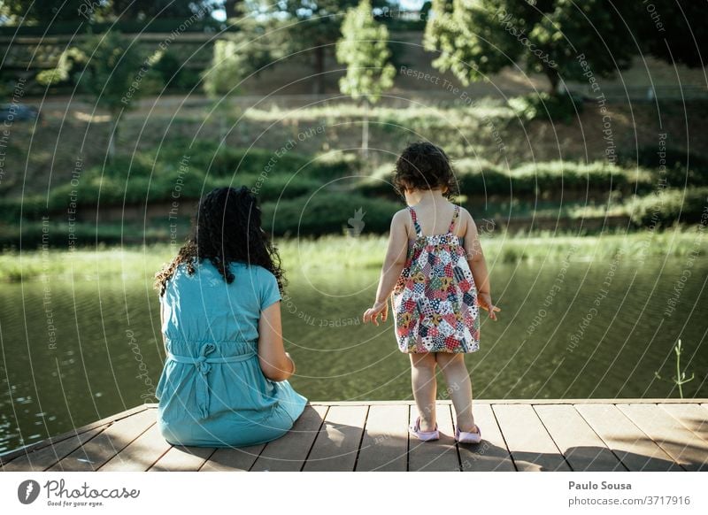 Mother and daughter looking at river Mother with child motherhood Daughter Child childhood Together Happiness Woman care people Love Parents Family & Relations