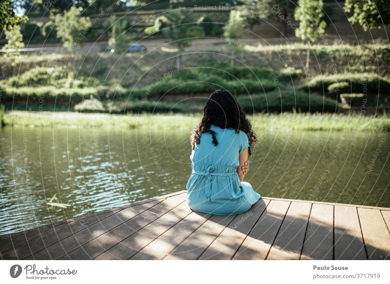 Rearview of a woman on the river River riverside Contemplative watching solitude alone Loneliness lonely Lovesickness Rear view Woman Caucasian looking thinking