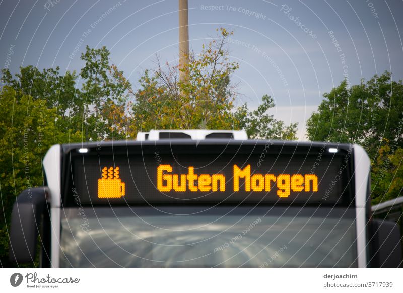 GUTEN MORGEN ..with coffee is standing on a bus with the graphic of a cup of coffee. Bus Transport Station Street Means of transport Exterior shot Colour photo