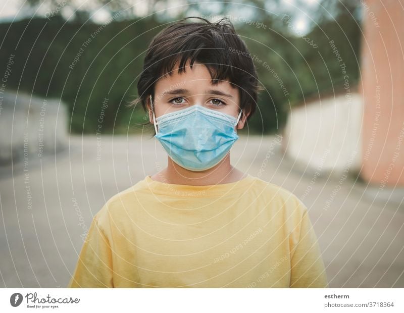 Close-up of kid wearing medical mask coronavirus epidemic pandemic quarantine child covid-19 symptom medicine health positive test hospital city gesture casual