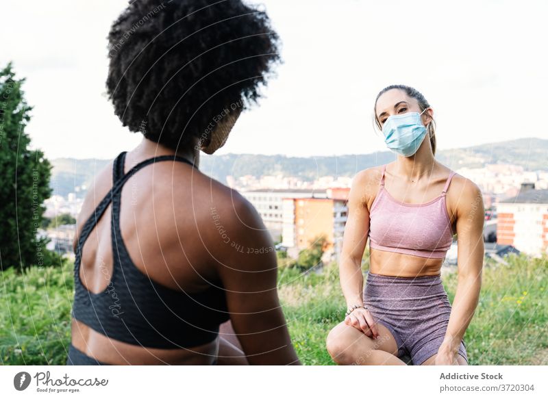 Young sportswomen in protective masks resting during workout fitness training sporty exercise coronavirus young multiracial multiethnic diverse african american