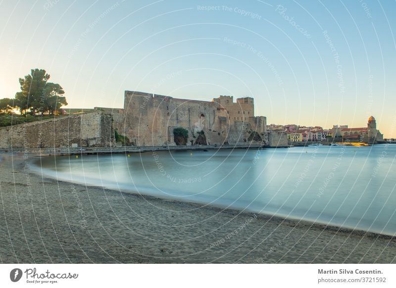 Old town of Collioure, France, a popular resort town on Mediterranean sea, panoramic view with the Royal castle in sunrise light ancient architecture beach