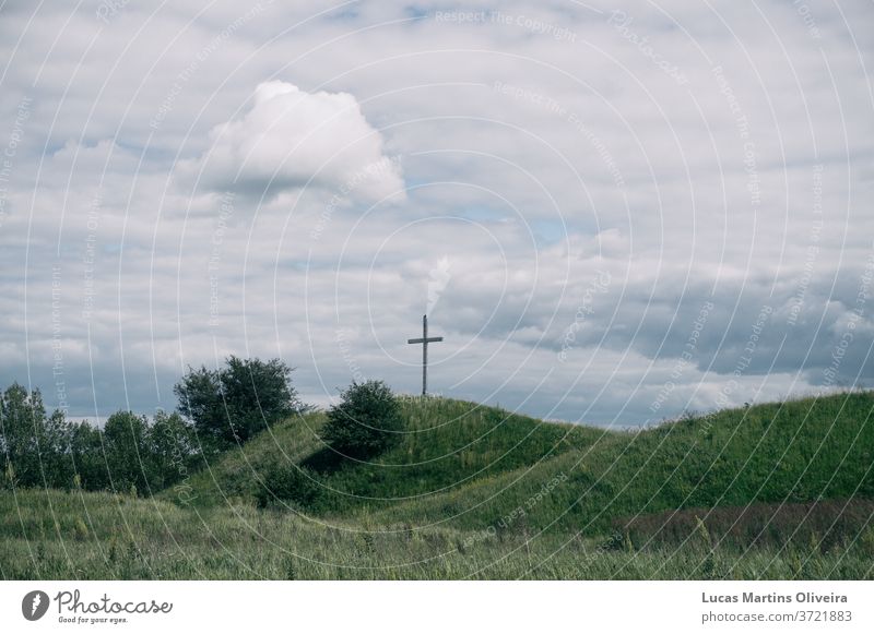 a cross in a green field Religion and faith religion jesus jesus christ god Christianity Christian cross church Inspiration motivation uplifting nature