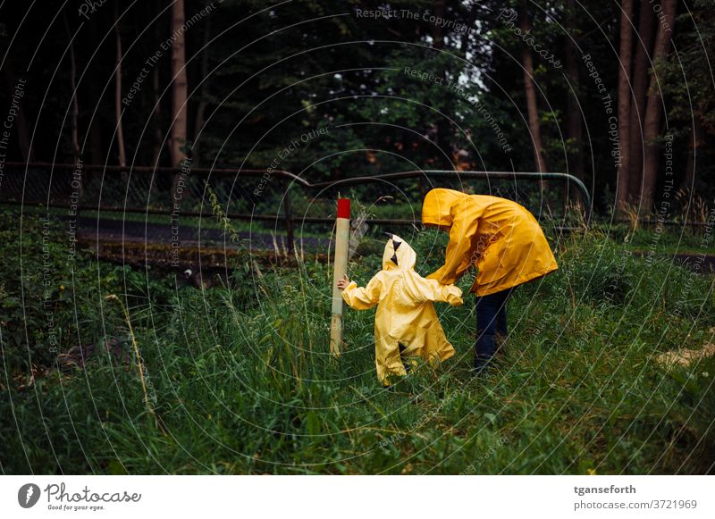 rainy days Child children Infancy Discover Playing Rain Rain jacket Brothers and sisters brotherly love Colour photo Together Exterior shot Bad weather out