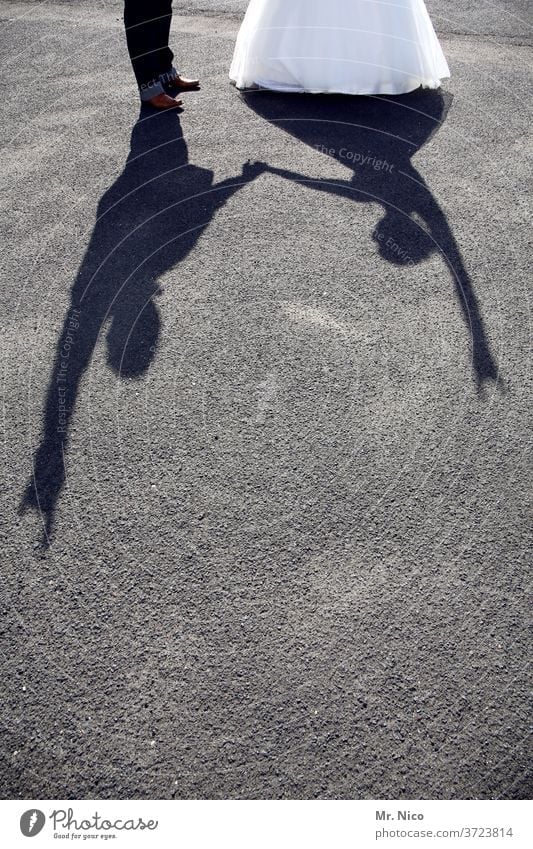 Rock'n'Roll wedding Shadow Light and shadow Silhouette Connectedness Friendship Man Woman luck Together Attachment Related Shadow play Posture Ground Asphalt