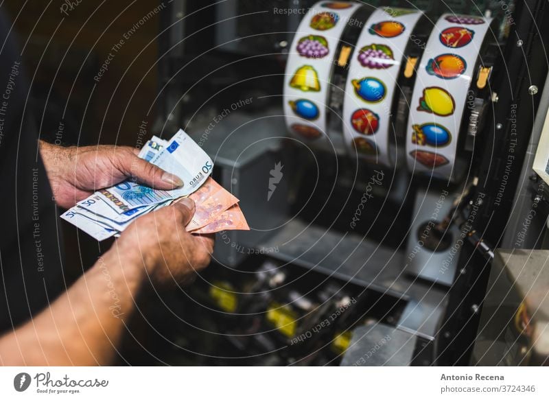 Man collects money from slot machines. Close-up of collecting machine. man repairing job work worker vice game economy gambling raise maintenance collection