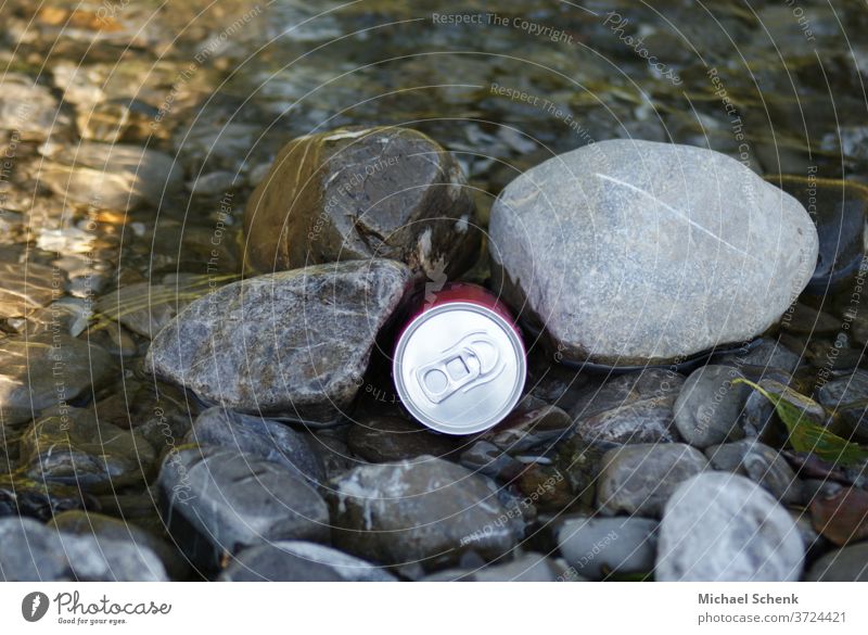 A beverage can between stones at a mountain stream Cans, stones, water, streams, mountains, Exterior shot Colour photo Adventure Exceptional Stone Brook Alps